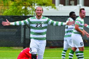 Lance Berry celebrates on the soccer field as a Wildcat