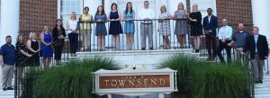 The teachers of the year line up for a photo on a staircase outside of the Townsend building.