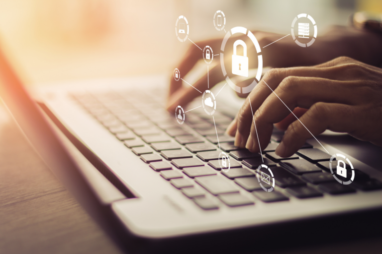 Hands type on a keyboard while cyber security icons float around