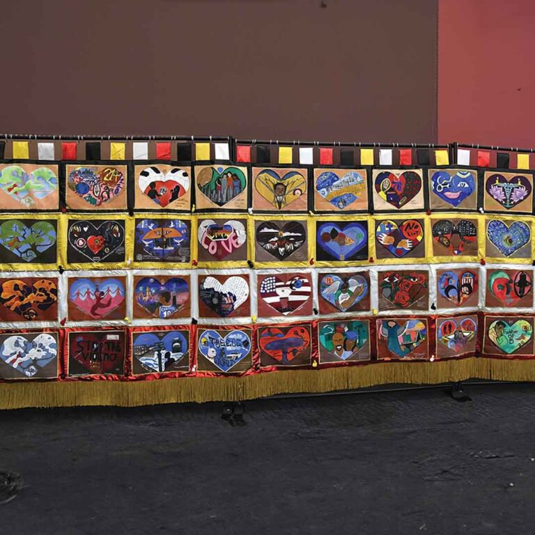 The “Healing Arts Anti-Gun Violence, The Power of Love” project resulted in this 20-by-8-foot tapestry focused on 36 families who lost loved ones to gun violence.