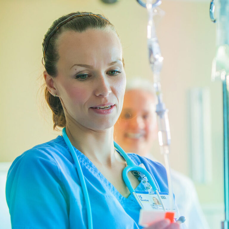 A nurse near a IV bag