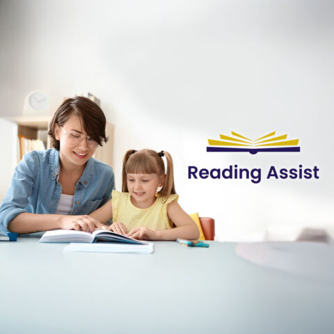 A teacher showing a young student how to read.