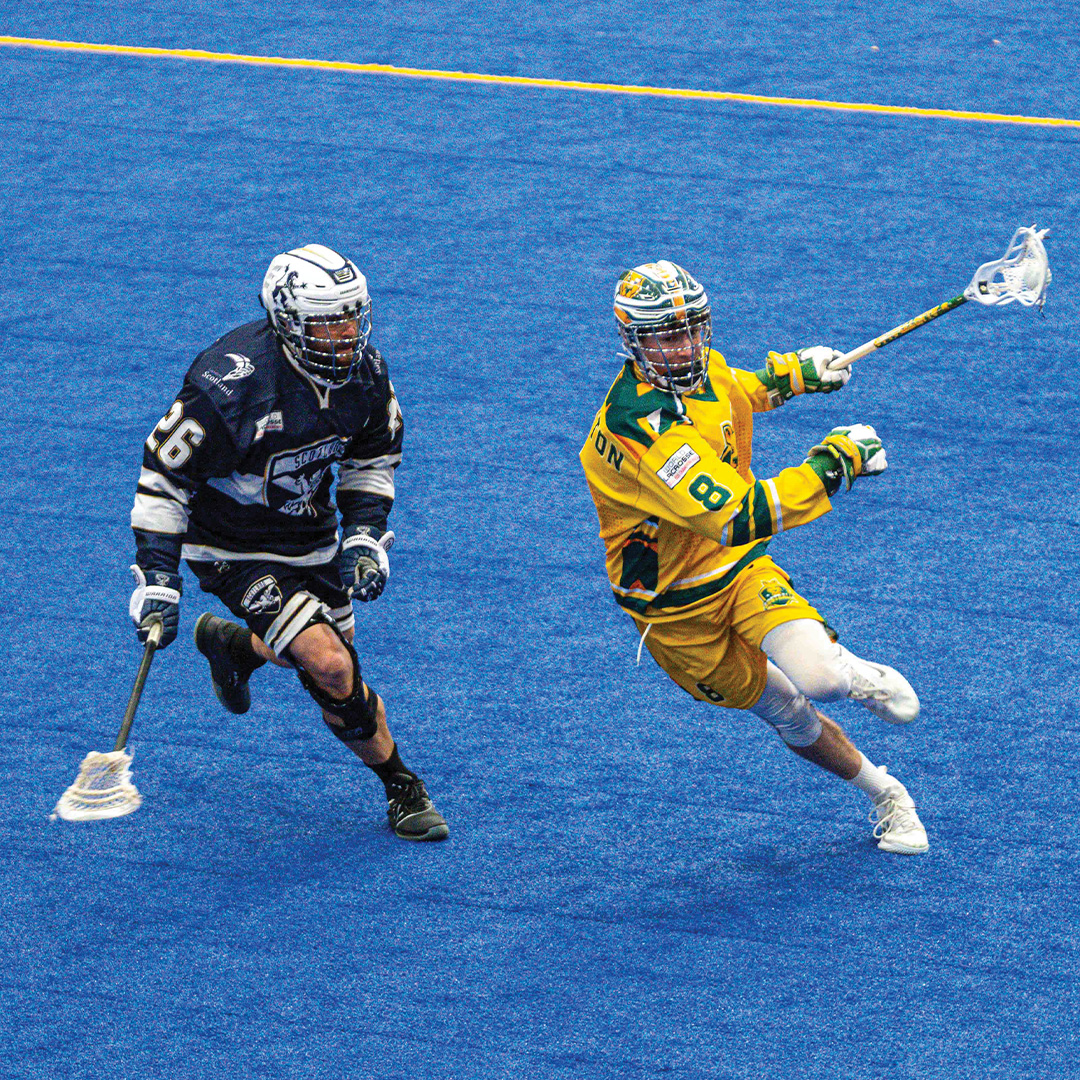 Toby Templeton playing in a indoor lacrosse field.