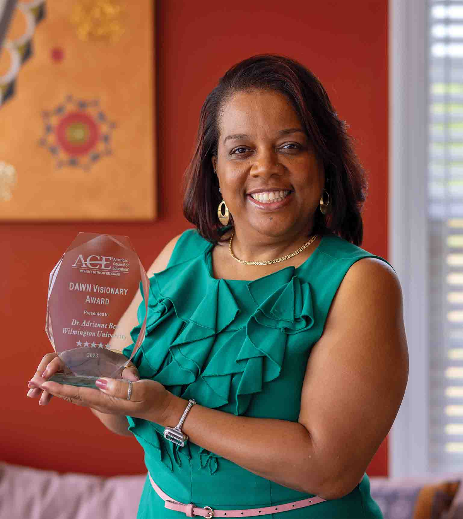 Dr. Bey holding her DAWN Visionary Award in 2023