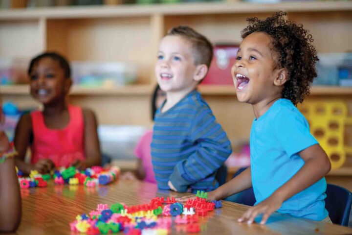 Children laughing and smiling in a classroom