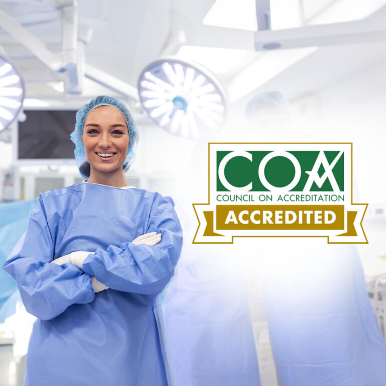 An anesthesiologist standing in an operating room. Beside her is the COA Accreditation seal.