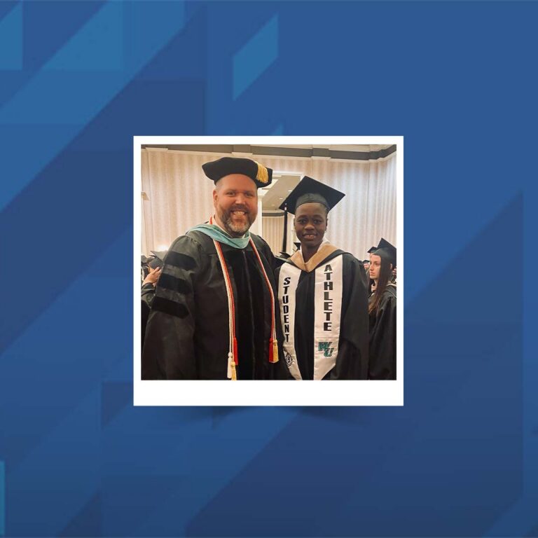Dr. Matt Wilson and a student photographed together at commencement.