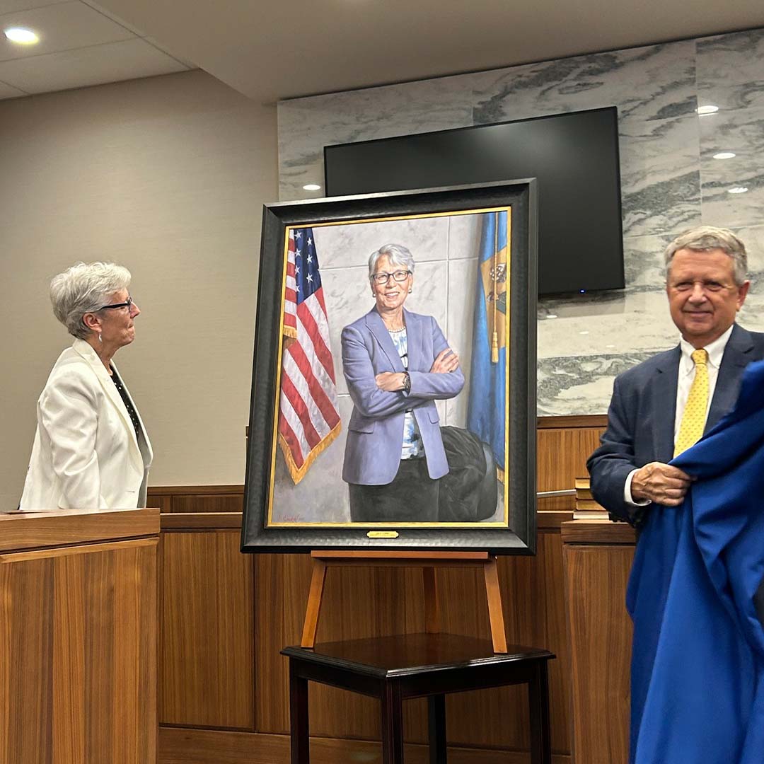 A photo of Jan Jurden seeing their portrait unveiling.
