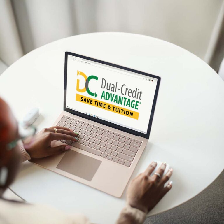 person on laptop reviewing Dual-Credit ADVANTAGE options.