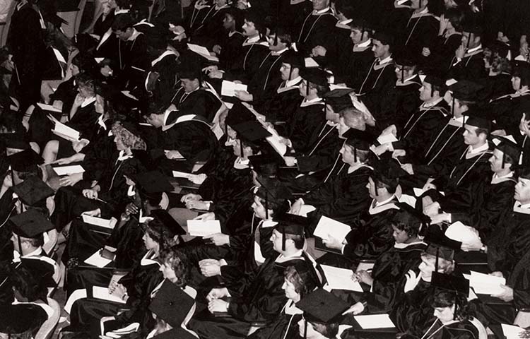 Students at the first commencement in caps and gowns.