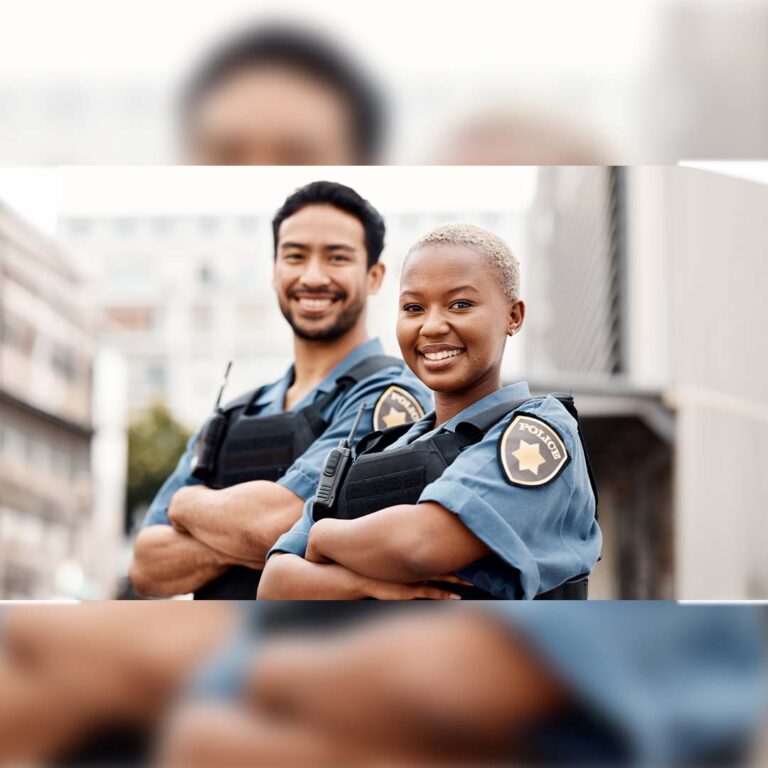 The police officers standing outside and smiling.