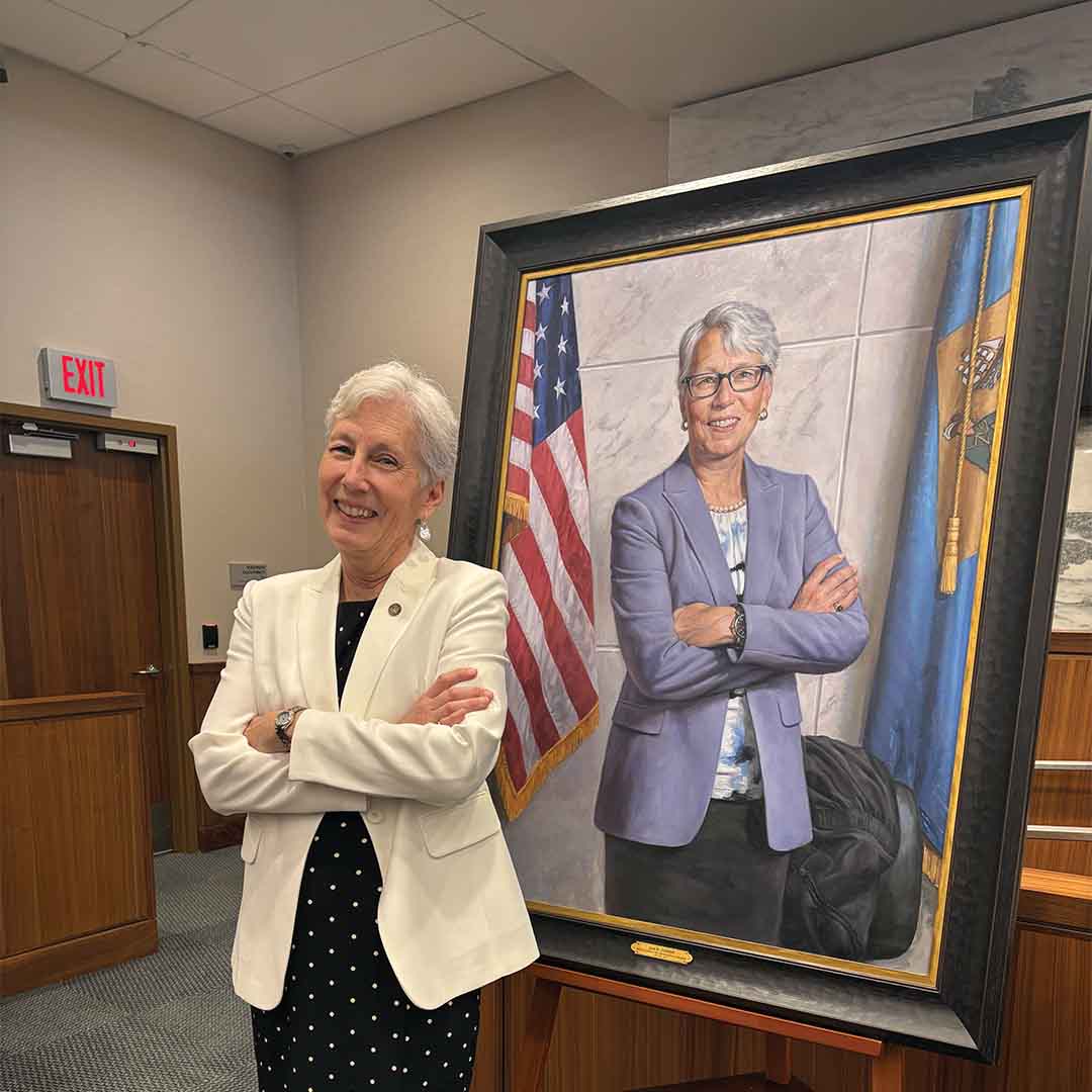 Dean Jan Jurden next to her portrait