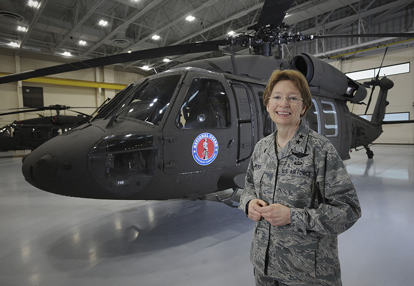 Carol Timmons in front of helicopter