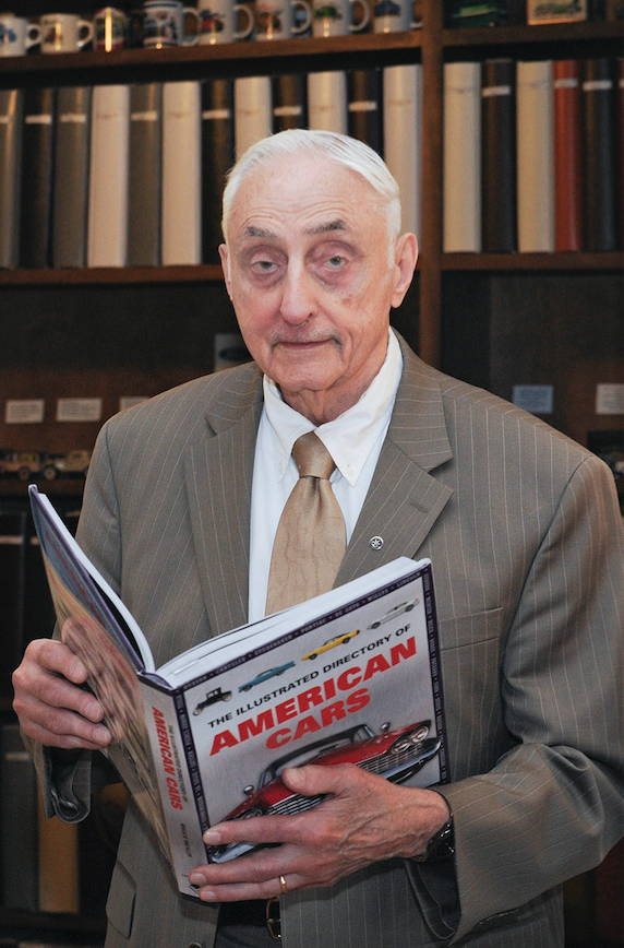 Dr. Gilbert holding book