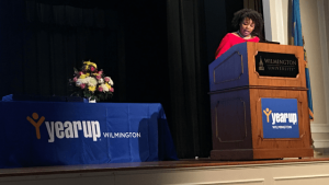 Alyssa Bradley (YU Student Services) speaks at a podium on stage