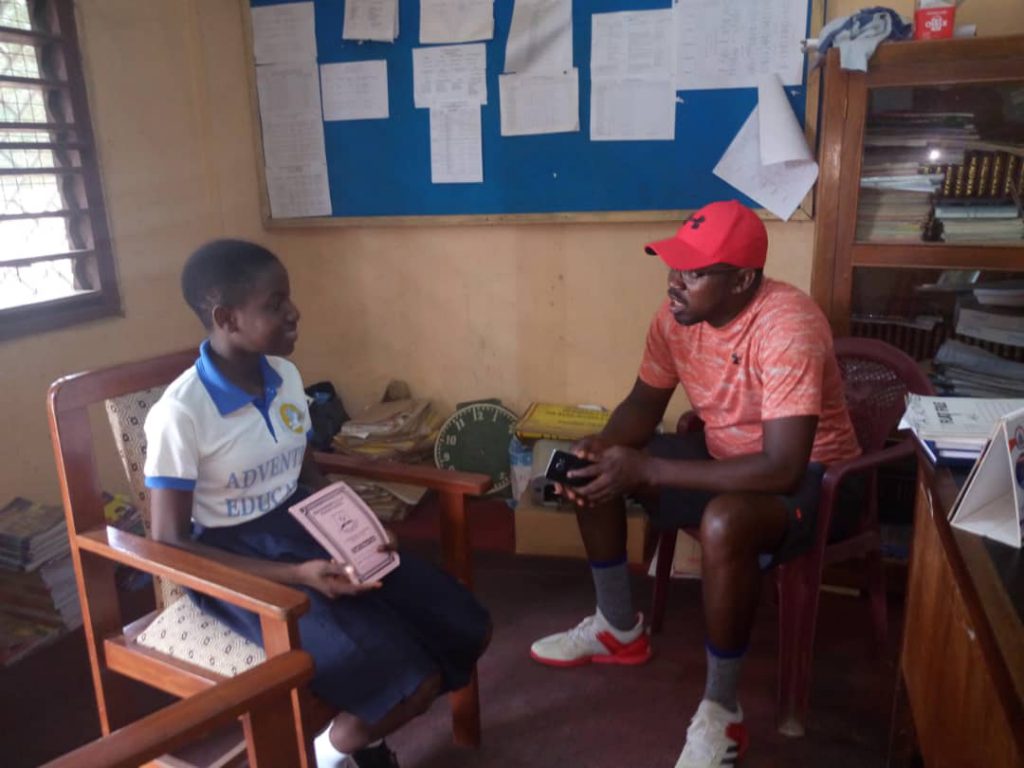 Frank visits with a sponsored student as part of his charity.