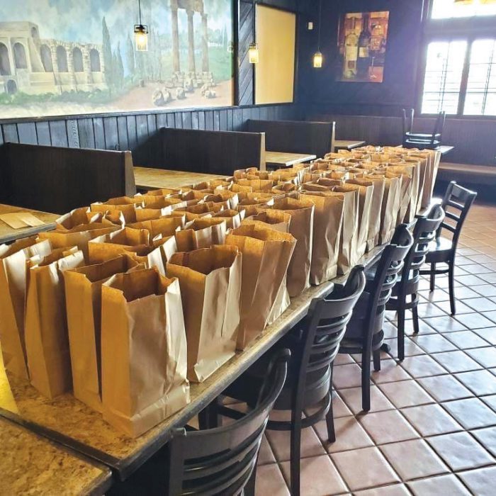 Lunch bags line a table