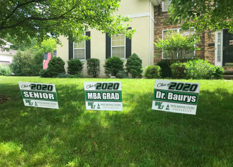 Front yard signs for all three Baurys graduating