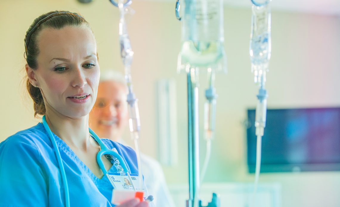A nurse near a IV bag