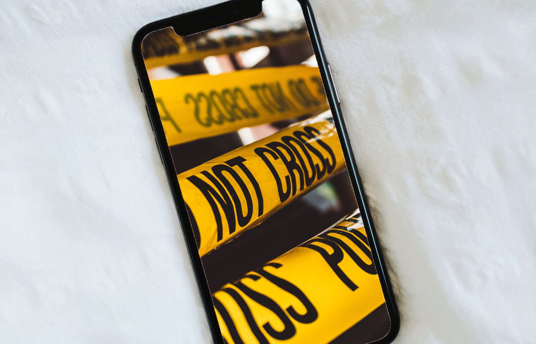 Cell phone with crime scene tape on screen