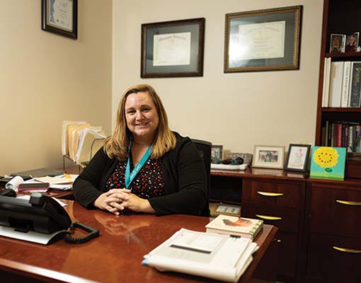 Dr. Mandy Bounds sitting at her work desk