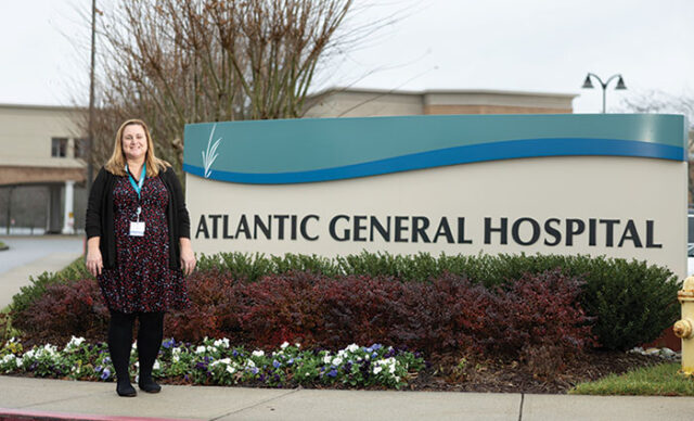 Dr. Mandy Bounds standing in front of the Atlantic General Hospital sign