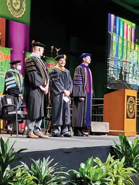 Dr. Gregor, center, at WilmU’s 2022 commencement ceremony.