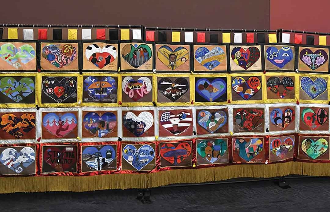 The “Healing Arts Anti-Gun Violence, The Power of Love” project resulted in this 20-by-8-foot tapestry focused on 36 families who lost loved ones to gun violence.
