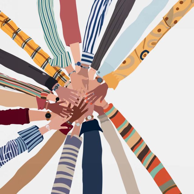 A diverse group of hands overlapping in the center, forming a circle. Each arm is dressed in different colorful sleeves, showcasing various patterns, stripes, and designs. The skin tones of the hands vary, symbolizing unity and teamwork.